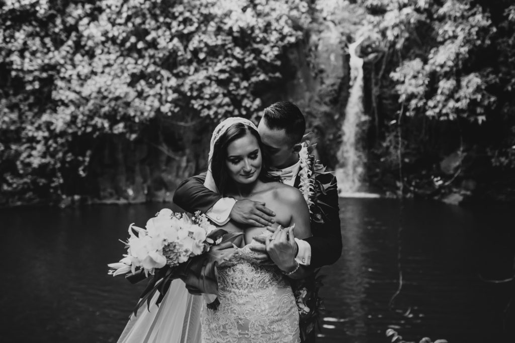 couple standing in front of the waterfall