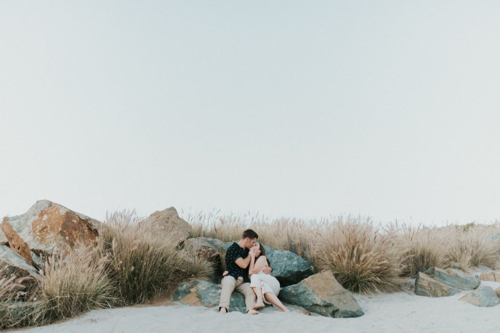 couple kissing on the rocks in Coronado 