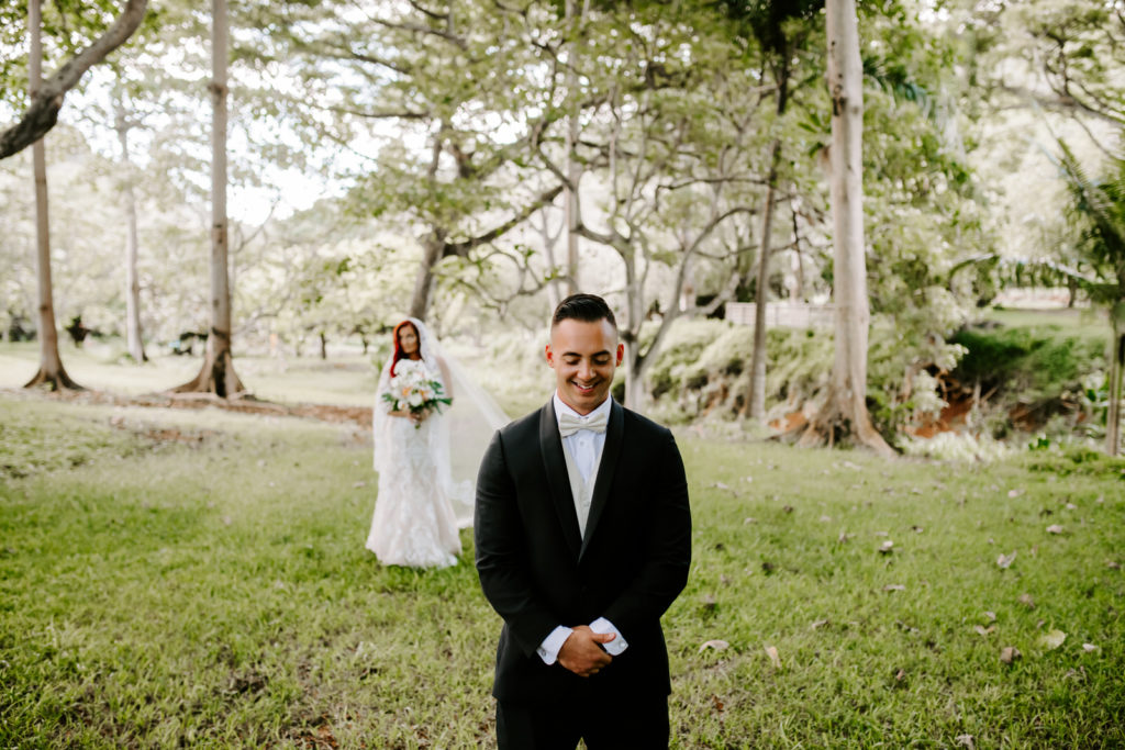 Bride and groom at their first look at hawaii destination wedding