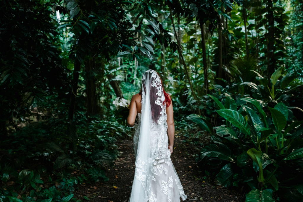 bride walking through botanical garden to the waterfall