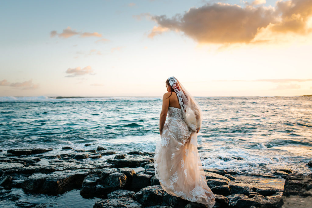 bride walking out onto the rocks
