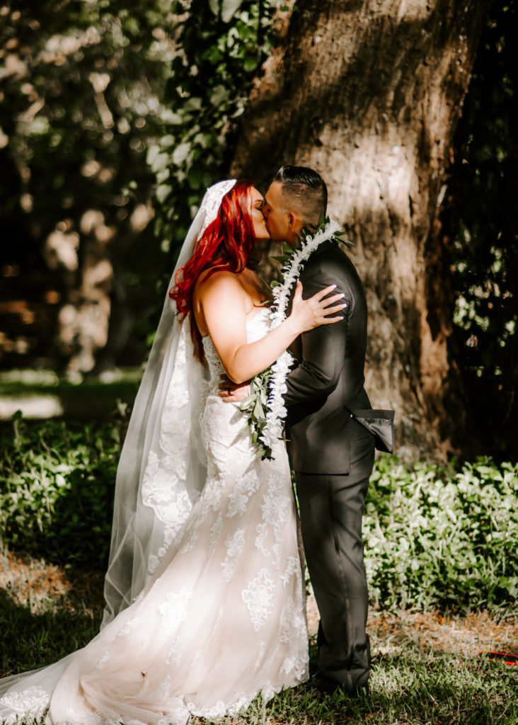 bride and grooms first kiss at hawaii destination wedding