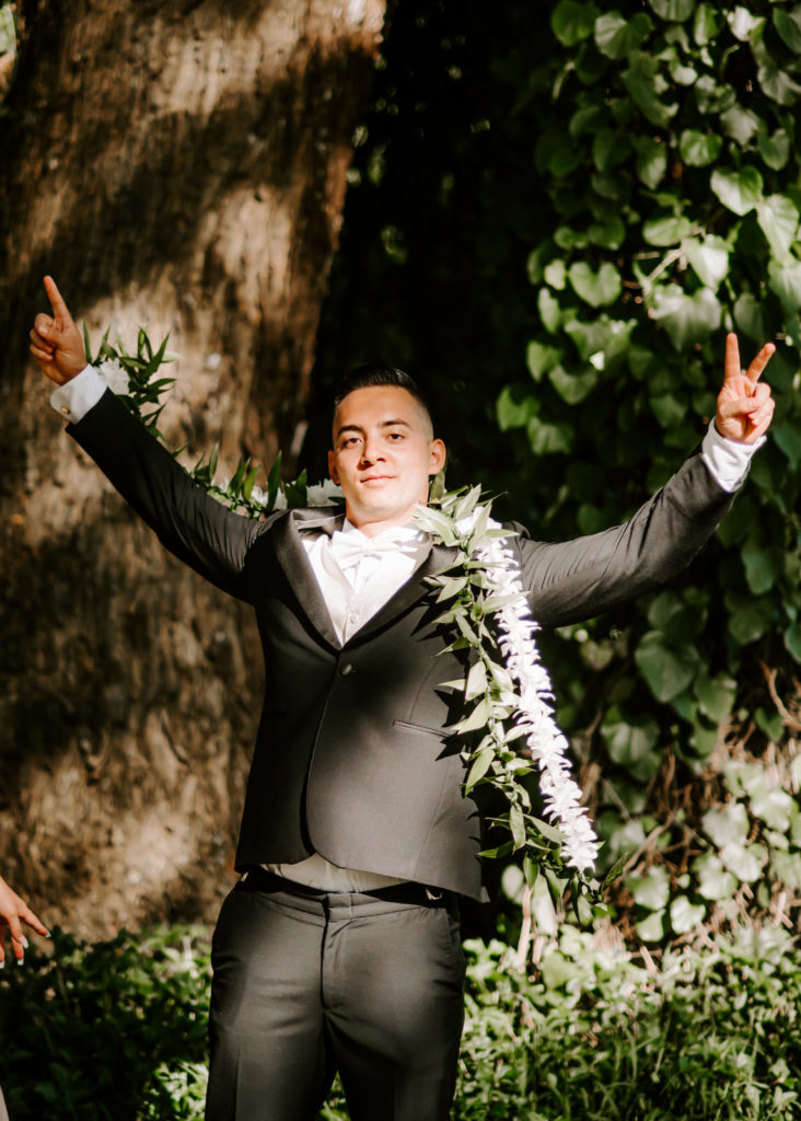 groom throwing up his hands in excitement