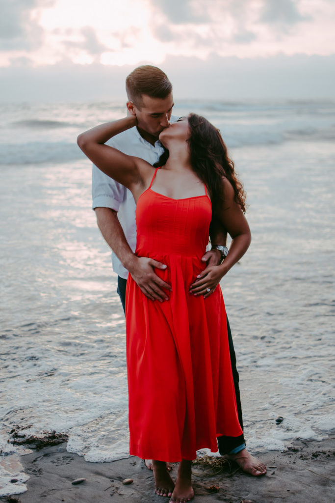 couple kissing near the shoreline