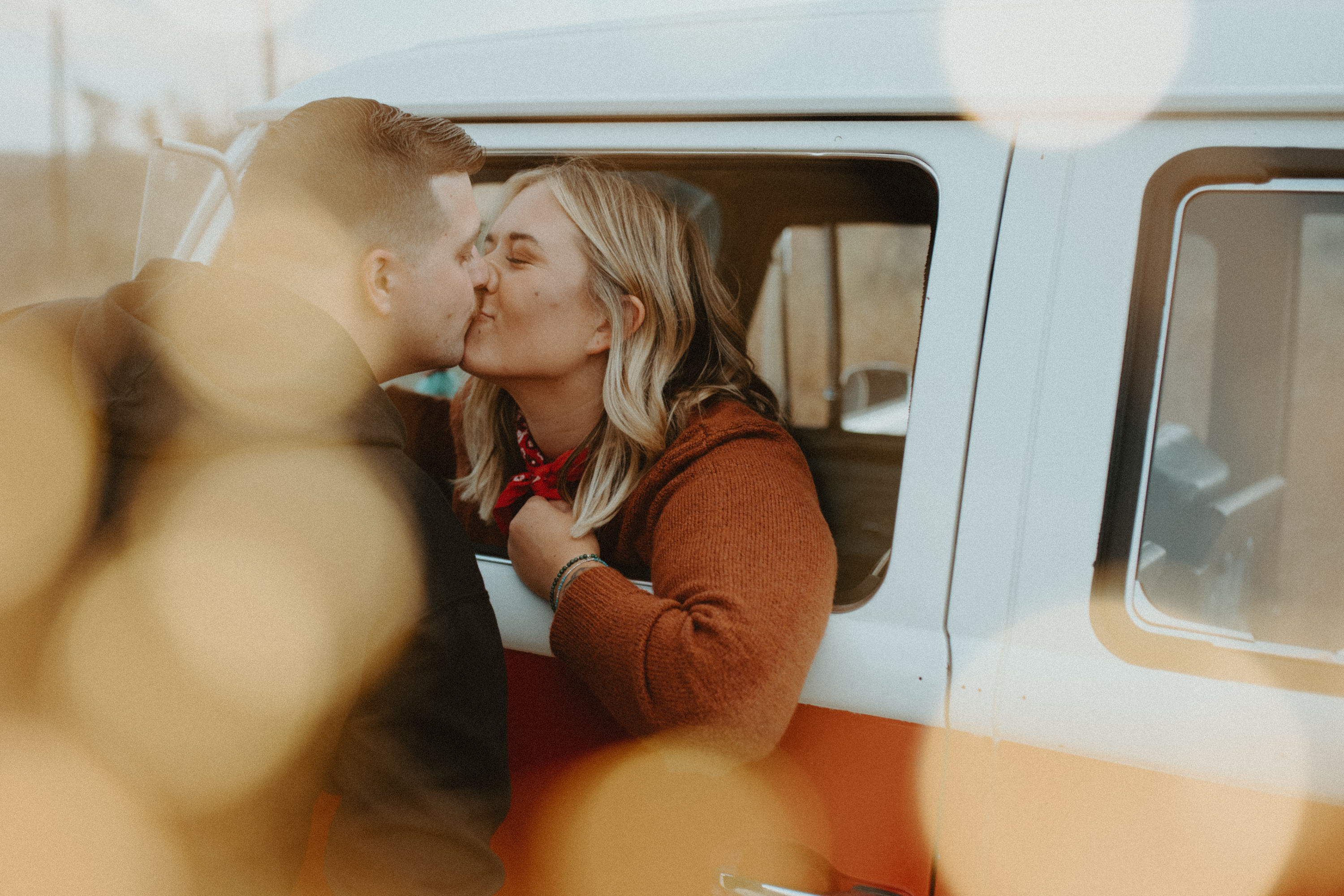 cute couple kissing in a VW bus - San diego engagement session