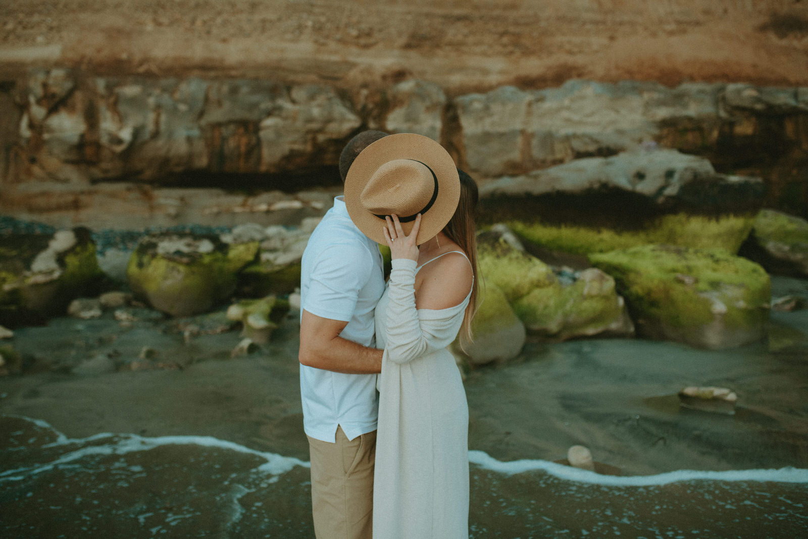 couple kissing at Carlsbad Cliffs during engagement session